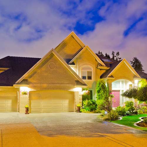 Exterior lighting illuminating a building and walkway