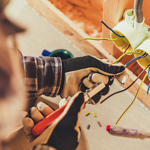 Residential electrician working inside a home