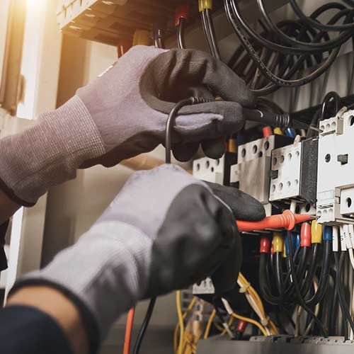 Electrician installing new wiring inside a building