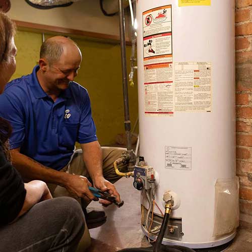 Electrician servicing a residential water heater